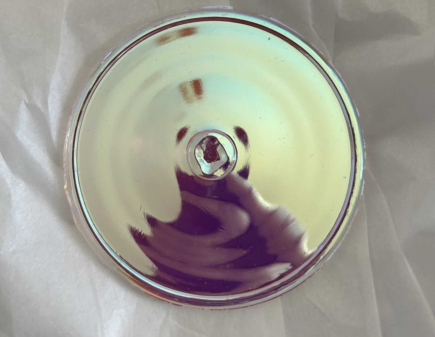 Round, mirrored disc.